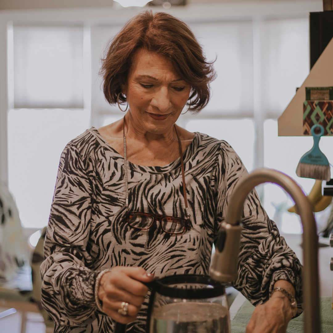 woman using an accessible faucet in the kitchen
